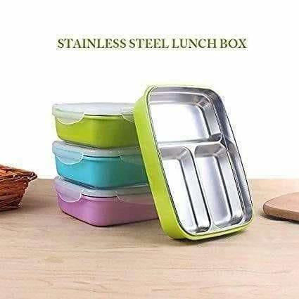 Stackable stainless steel lunch boxes with colorful lids on a wooden surface.