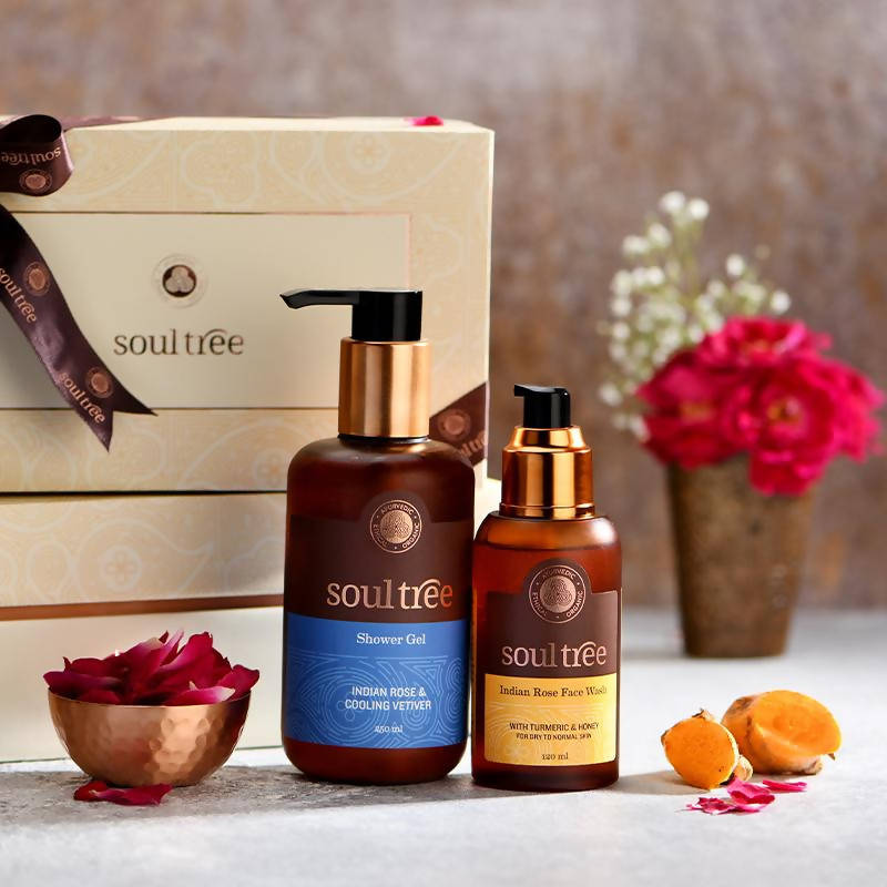 Two 'soultee' skincare products on a table with decorative elements.