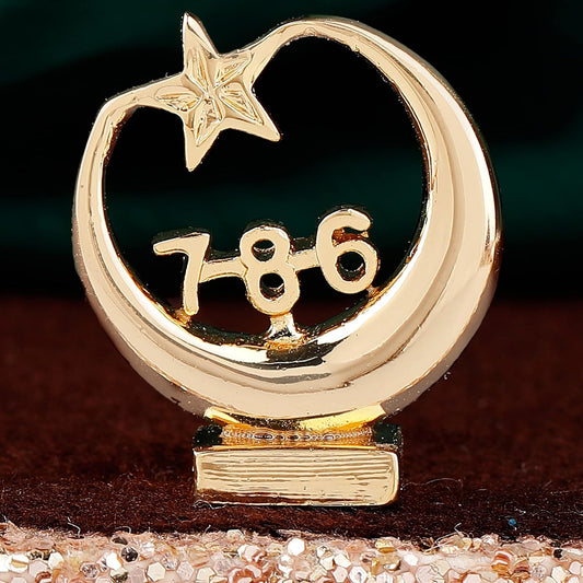 Gold decorative item with a star and number '786' on a dark background