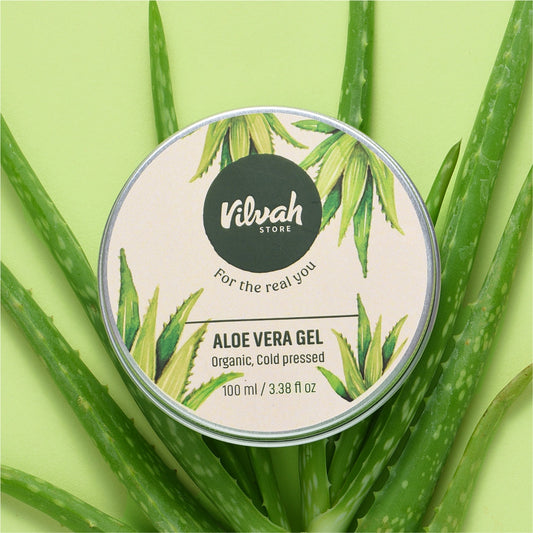 Vilvh Store Aloe Vera Gel container surrounded by aloe vera leaves on a green background
