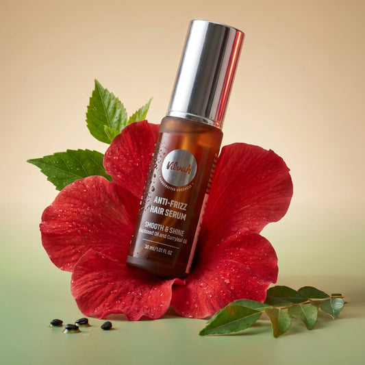 Hair serum bottle on a red flower petal with green leaves