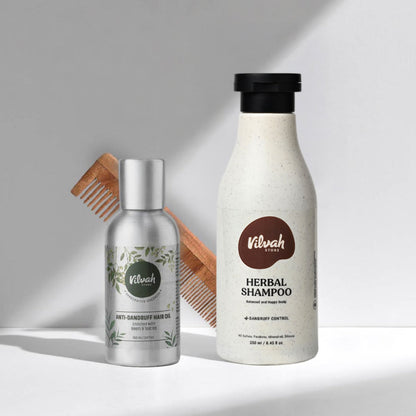 Vilvah hair care products including a bottle of shampoo, a bottle of hair oil, and a wooden comb on a light gray background.