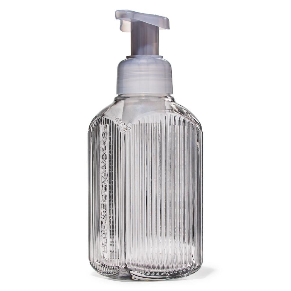 Clear ribbed soap dispenser with pump on a white background