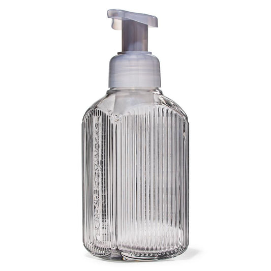 Clear ribbed soap dispenser with pump on a white background