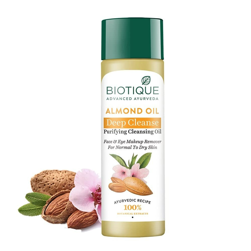 Bottle of Biotique Advanced Ayurveda Bio Almond Oil Purifying Cleansing Oil with almonds and flowers displayed in the background.