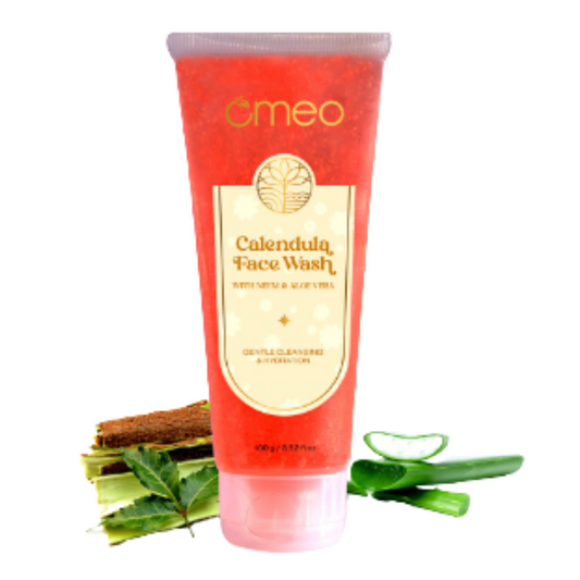 Red tube of Omeo Calendula Face Wash with aloe vera leaves on a white background