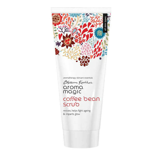 Tube of Aroma Magic coffee bean scrub with floral design on a white background