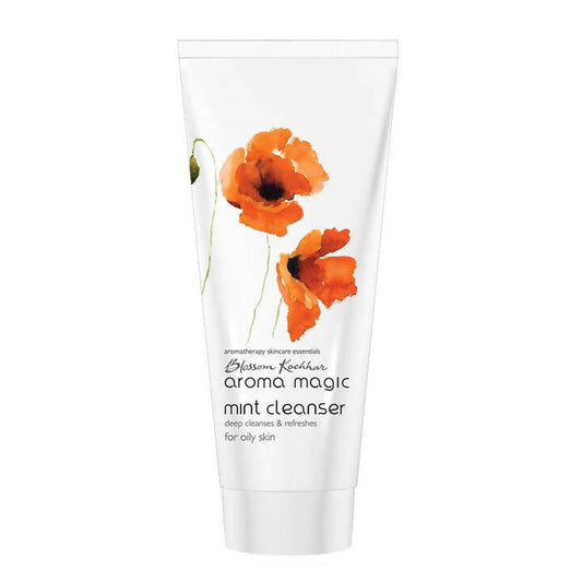 Tube of Aroma Magic mint cleanser with orange flowers on a white background