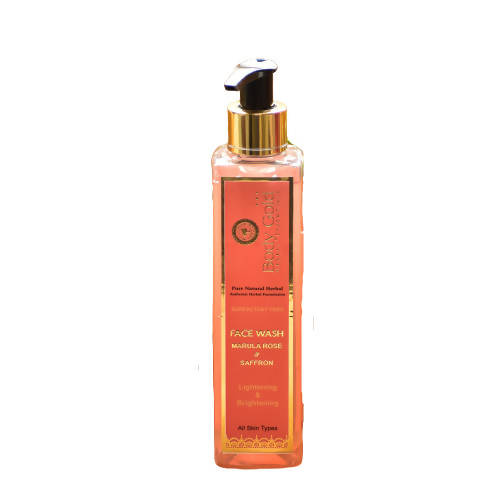 Orange face wash bottle with pump on a white background