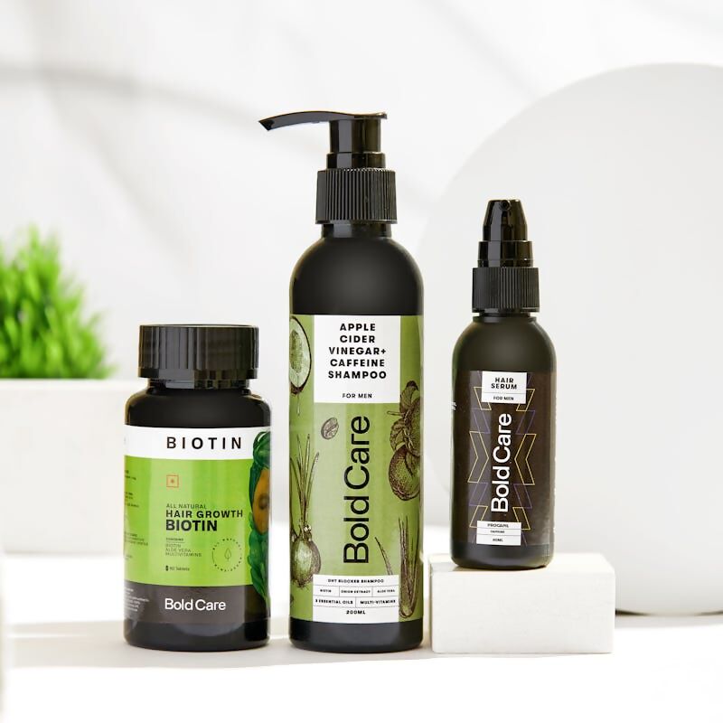 Collection of Bold Care hair care products on a white surface with a blurred background