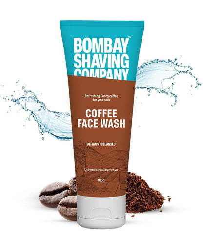 Tube of Bombay Shaving Company Coffee Face Wash with coffee grounds and water splash on a white background