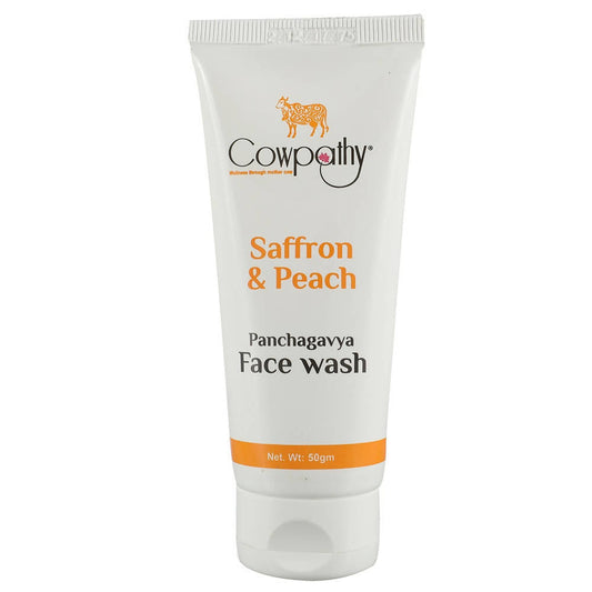 A tube of Cowpathy Saffron & Peech Panchagavya Face Wash against a white background.