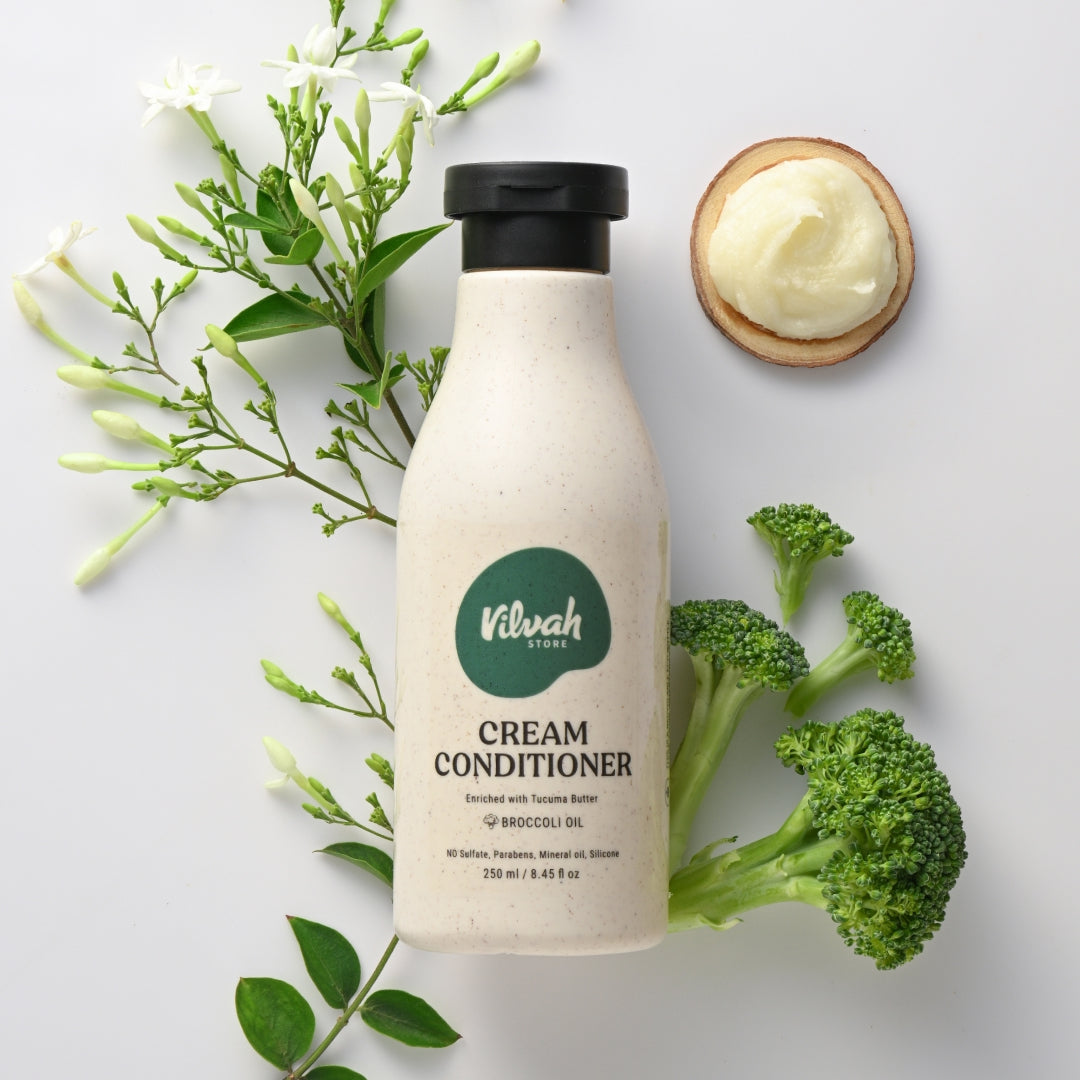 Vilvah Cream Conditioner bottle with broccoli and green leaves on a white background