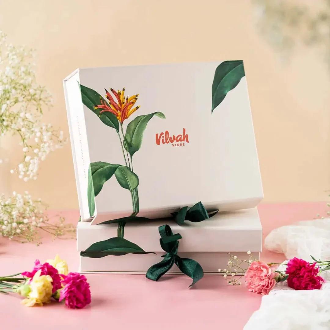 Gift box with floral design and 'Vilvah' branding on a pink background