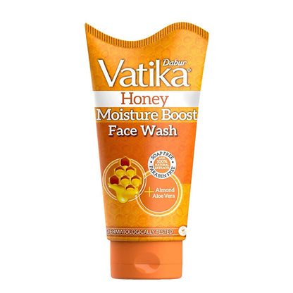 A tube of Dabur Vatika Honey Moisture Boost Face Wash with orange packaging.