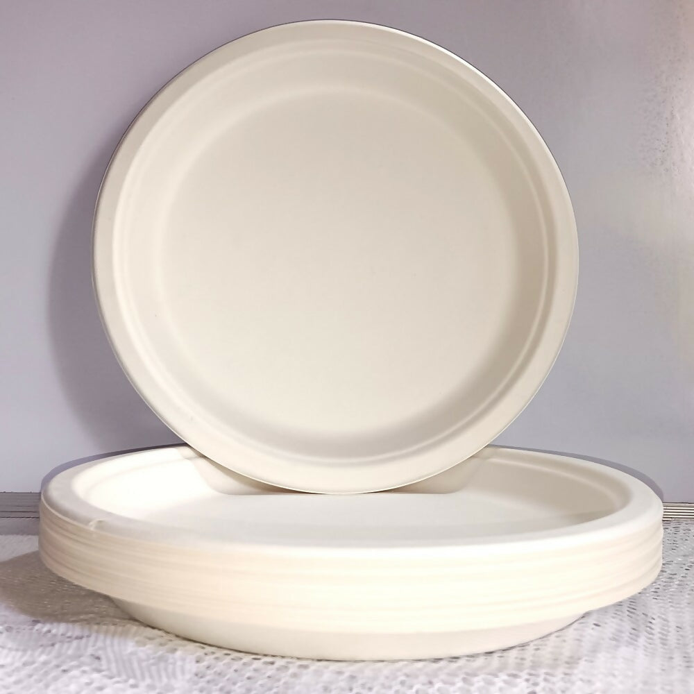 Two white ceramic plates on a textured surface with a light gray background