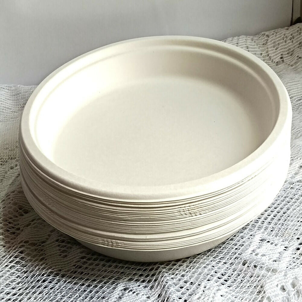Stack of white ceramic bowls on a textured surface with a neutral background