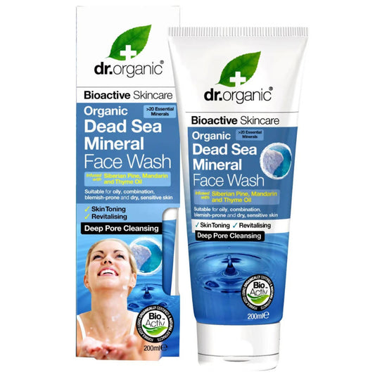Packaging of Dr.Organic Dead Sea Mineral Face Wash with a white and blue color scheme featuring an image of a smiling woman and product details.