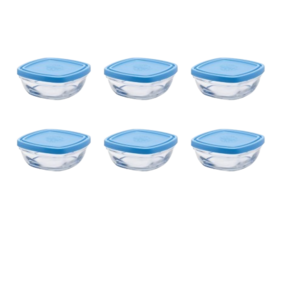 Set of six glass food storage containers with blue lids on a white background