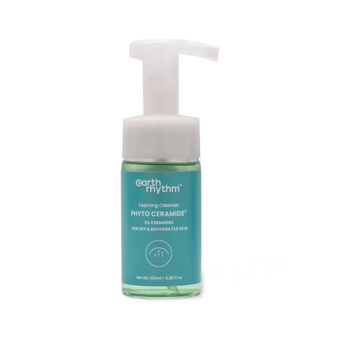 A pump bottle of Earth Rhythm Phyto Ceramide Foaming Cleanser with teal liquid visible inside.