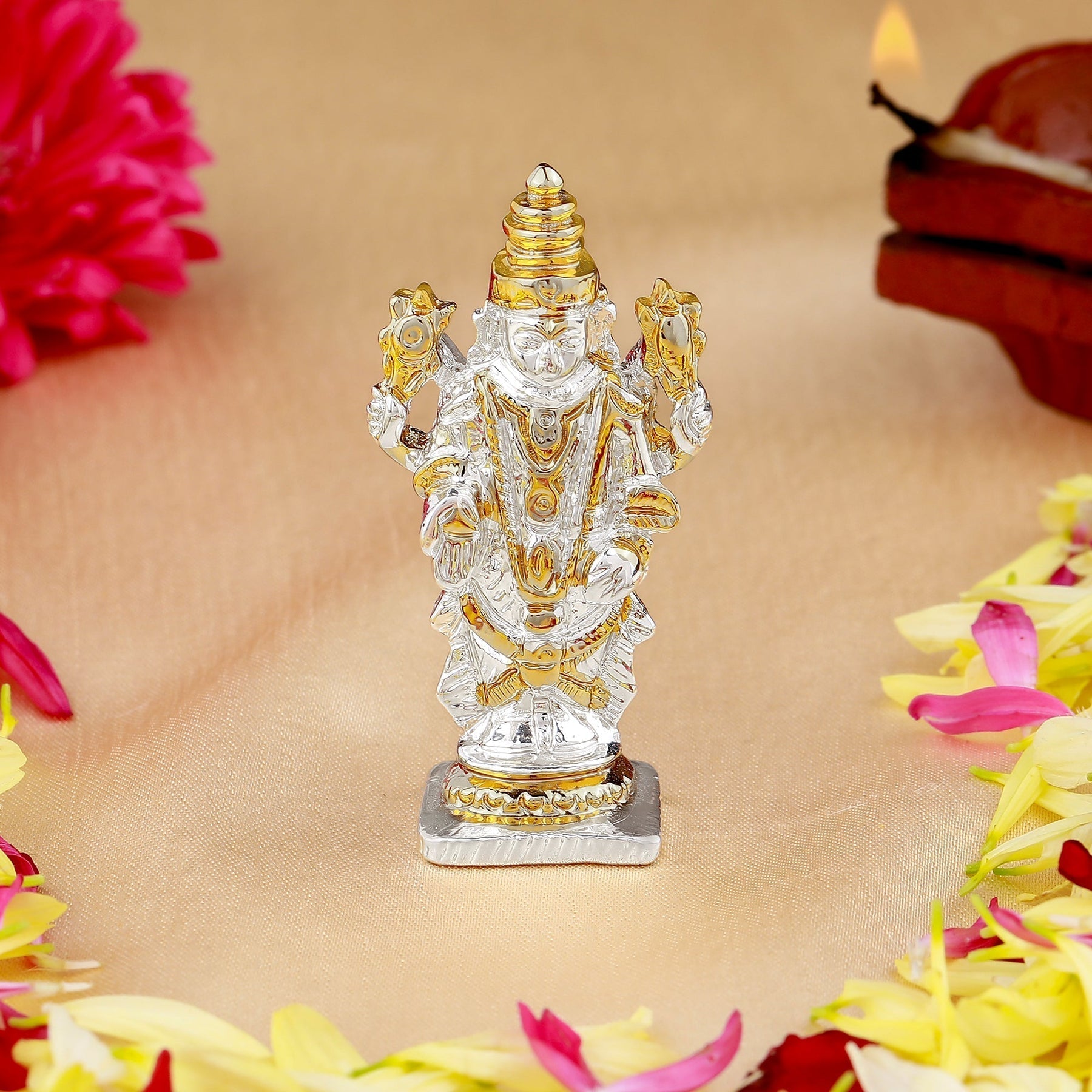 Decorative statue of a神灵 surrounded by flowers on a beige background