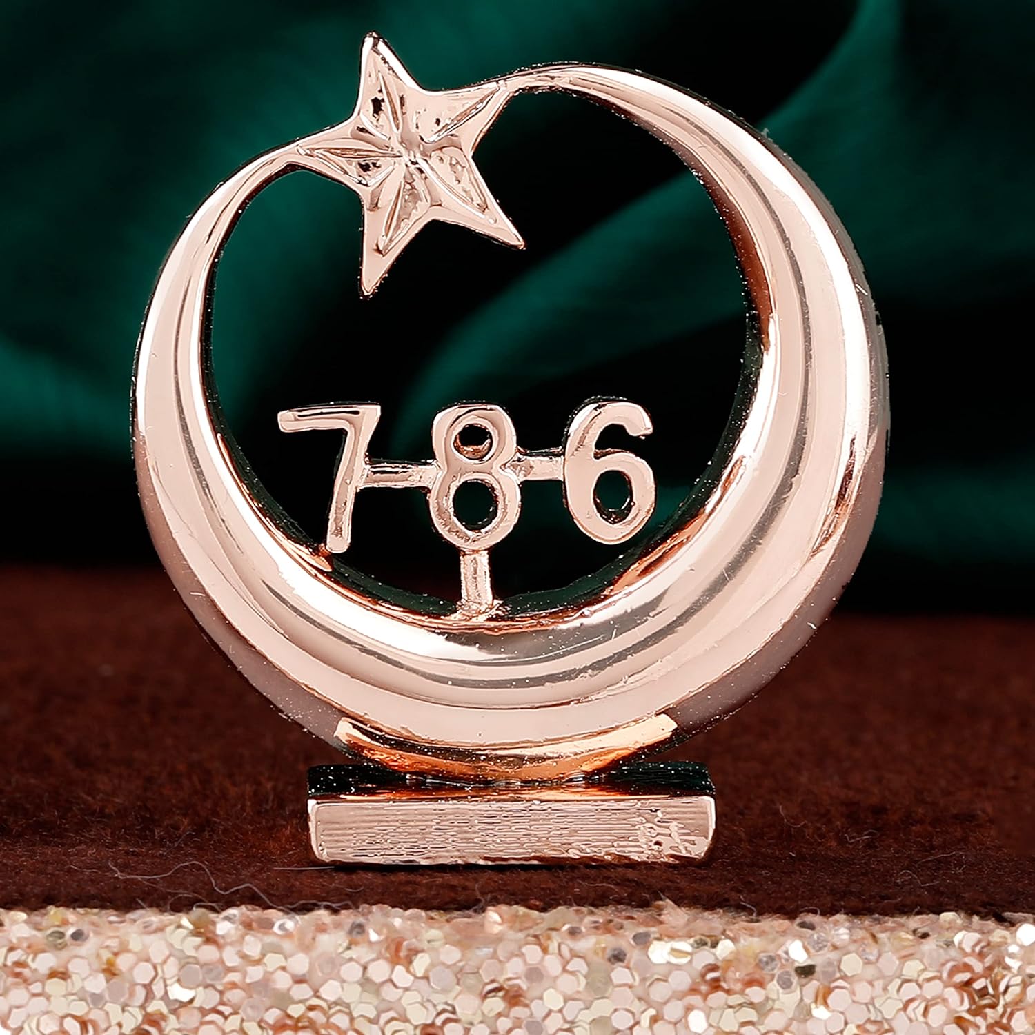 Rose gold emblem with number '786' and star on a dark background