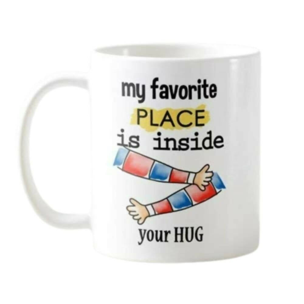 White mug with colorful arms and text 'my favorite place is inside your HUG' on a white background