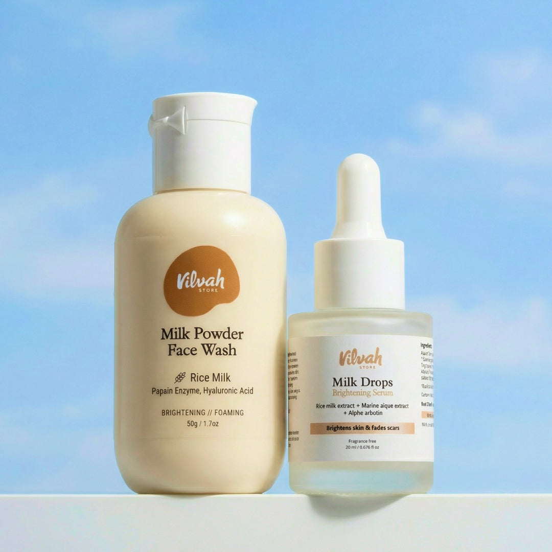 Two skincare products, Milk Powder Face Wash and Milk Drops, by Vilvah against a blue sky background.