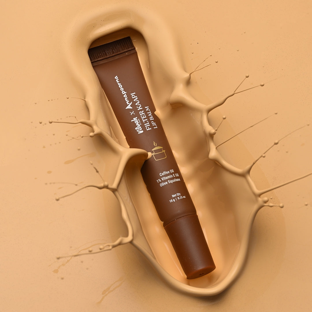 Lip balm in a brown tube with visible branding on a beige background