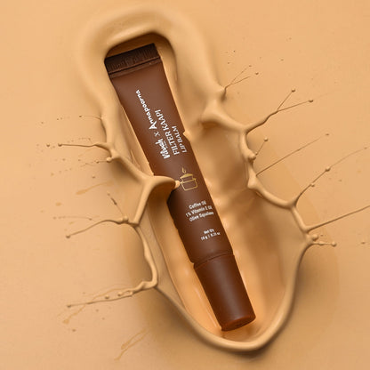 Lip balm in a brown tube with visible branding on a beige background