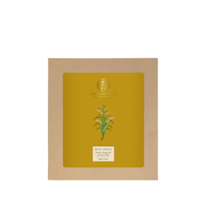 Yellow face mask with green leaf design in a cardboard box on a white background