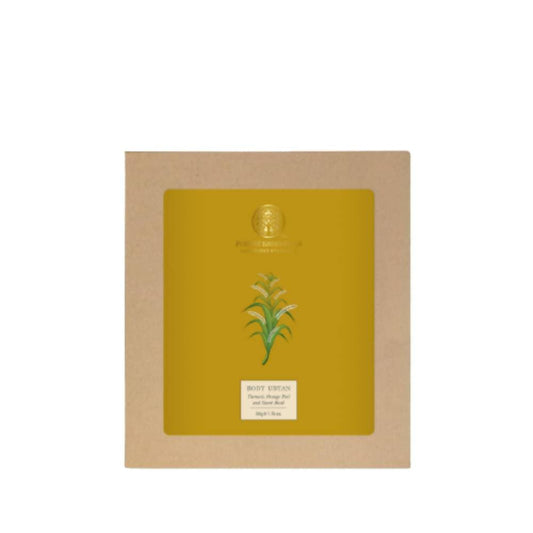 Yellow face mask with green leaf design in a cardboard box on a white background