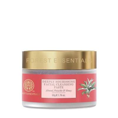 Facial cleansing paste jar with gold lid and red label on a white background