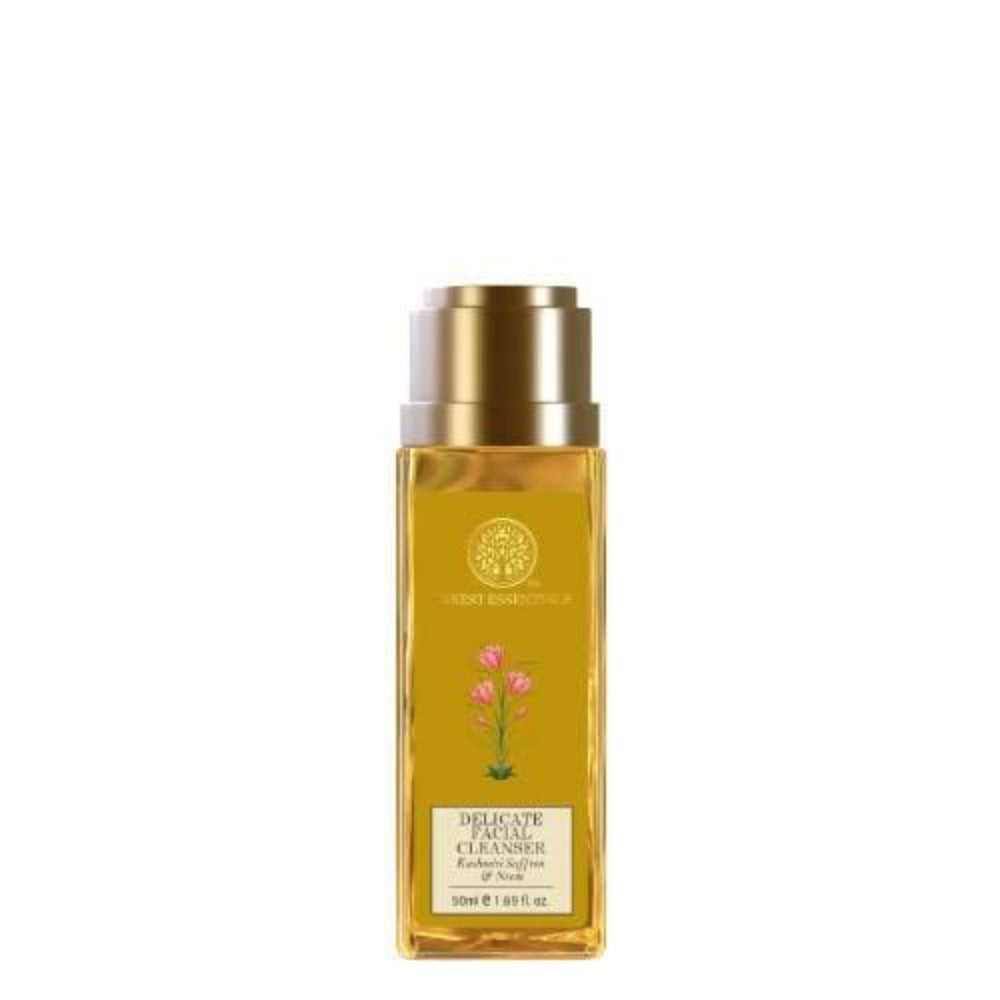 A clear bottle with a gold-colored cap containing the Forest Essentials Delicate Facial Cleanser, labeled with the brand's logo and floral imagery.