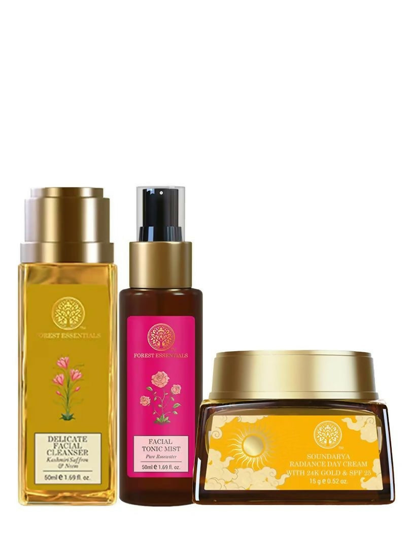 Three skincare products with gold and pink packaging on a white background