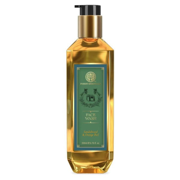 Gold bottle of face wash with a green label on a white background