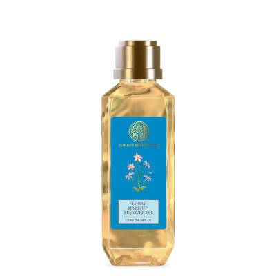 A clear glass bottle with a gold cap and blue label, containing Forest Essentials Floral Make Up Remover Oil.