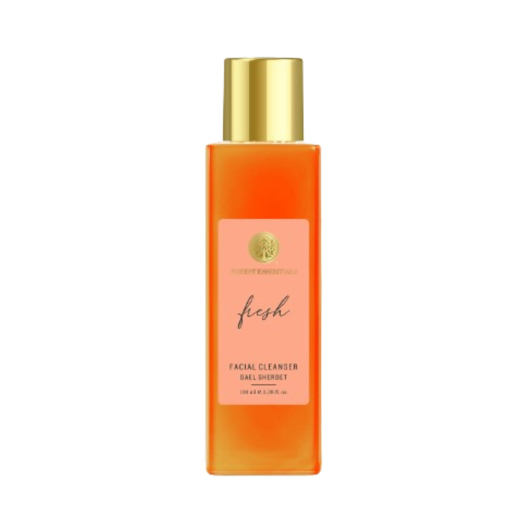 Orange facial cleanser bottle with gold cap on a white background