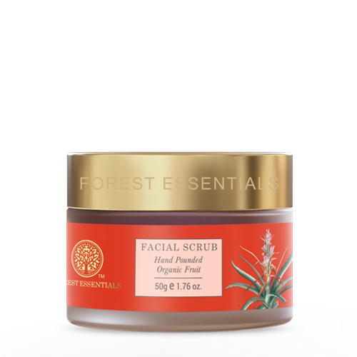 Forest Essentials facial scrub jar with red label and gold lid on white background