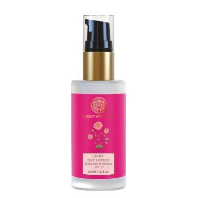 Skincare bottle with pink label and gold cap on white background