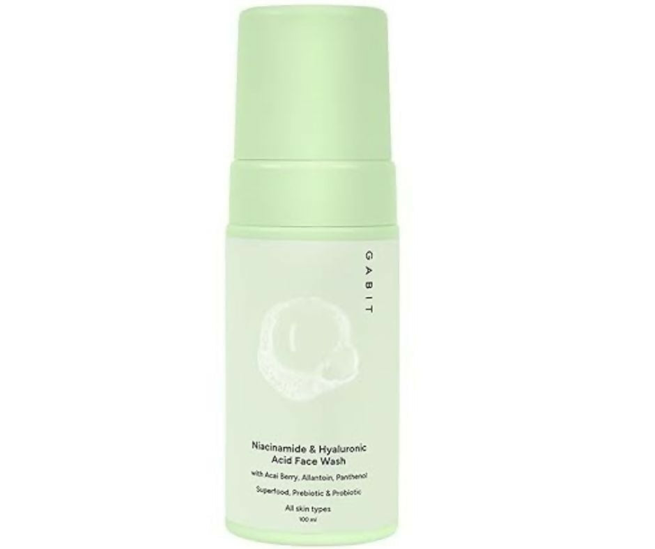 Green bottle of facial wash with brand logo on a white background