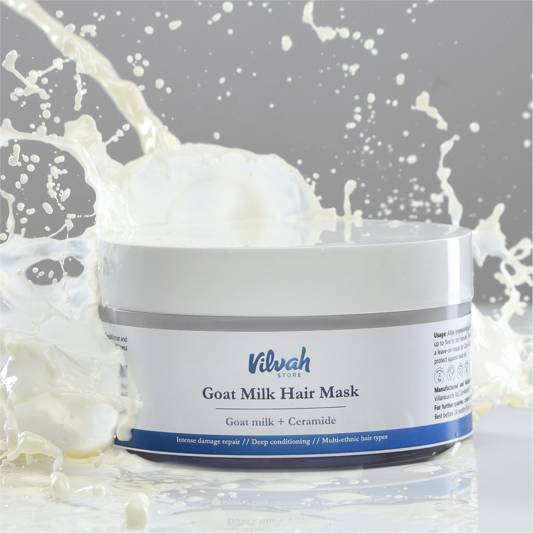 Jar of Viluh Goat Milk Hair Mask with splashes of milk on a gray background