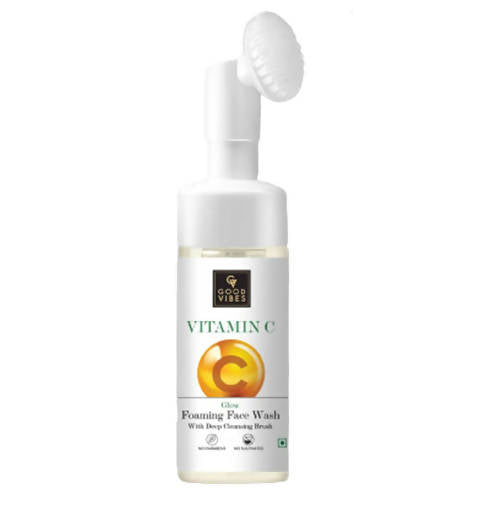 Vitamin C face wash bottle with a brush on a white background