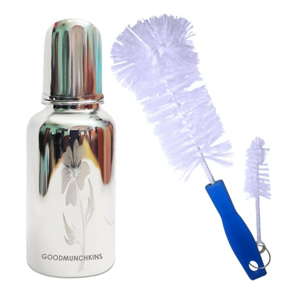 Bottle with silver cap and white design, accompanied by a cleaning brush with a blue handle on a white background.
