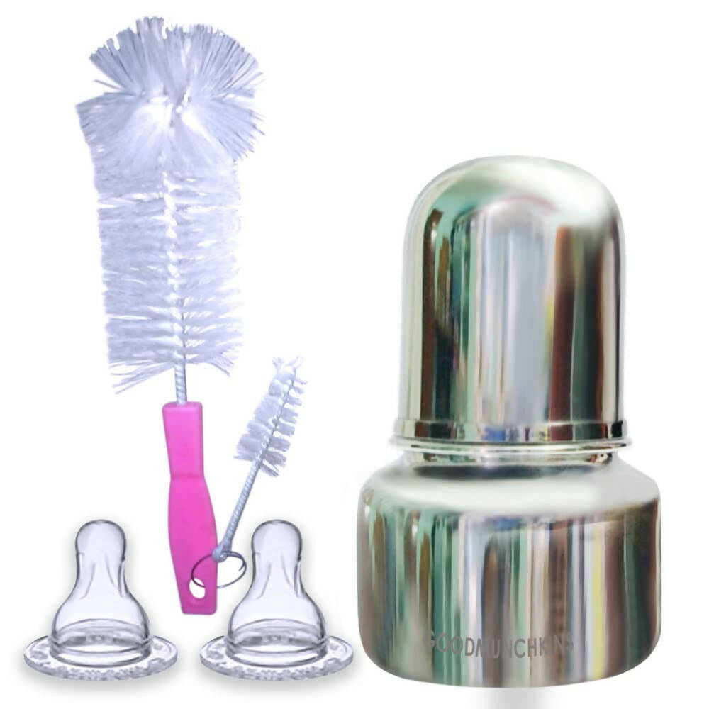 Bottle cap, two bottle nozzles, and a cleaning brush on a white background