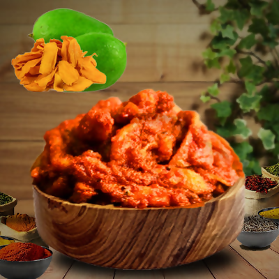 Bowl of red curry paste with turmeric and lime on a wooden surface