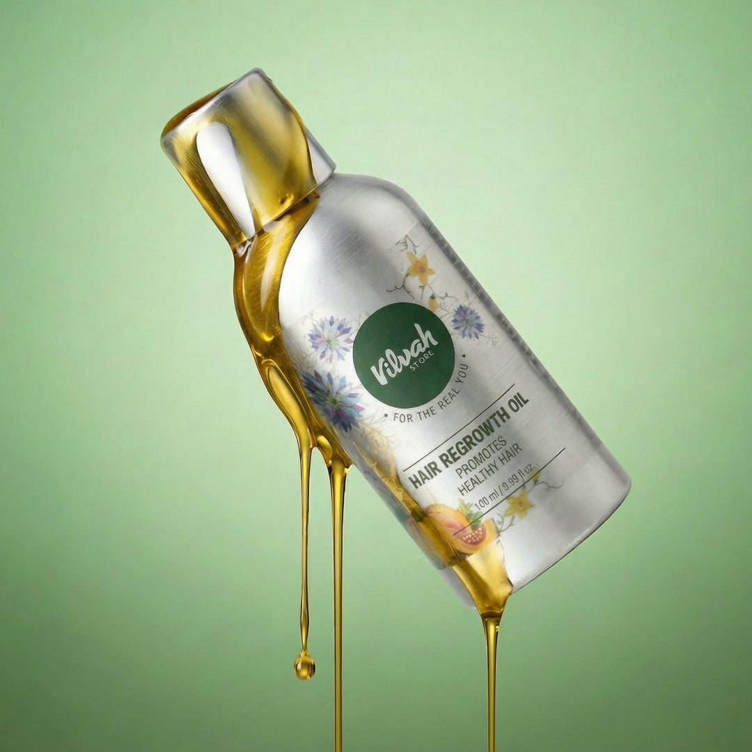 Bottle of Vilash hair regrowth oil with oil dripping, on a green background