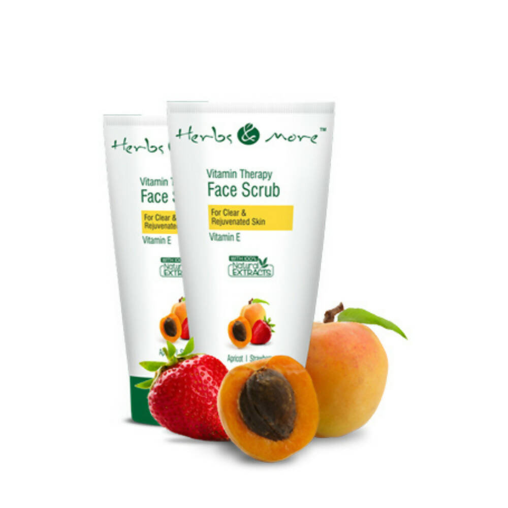 Two tubes of 'Herbs & More' Vitamin Therapy Face Scrub with fruits on a white background