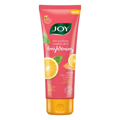 Joy brightening scrub tube with mandarin and green tea on a white background