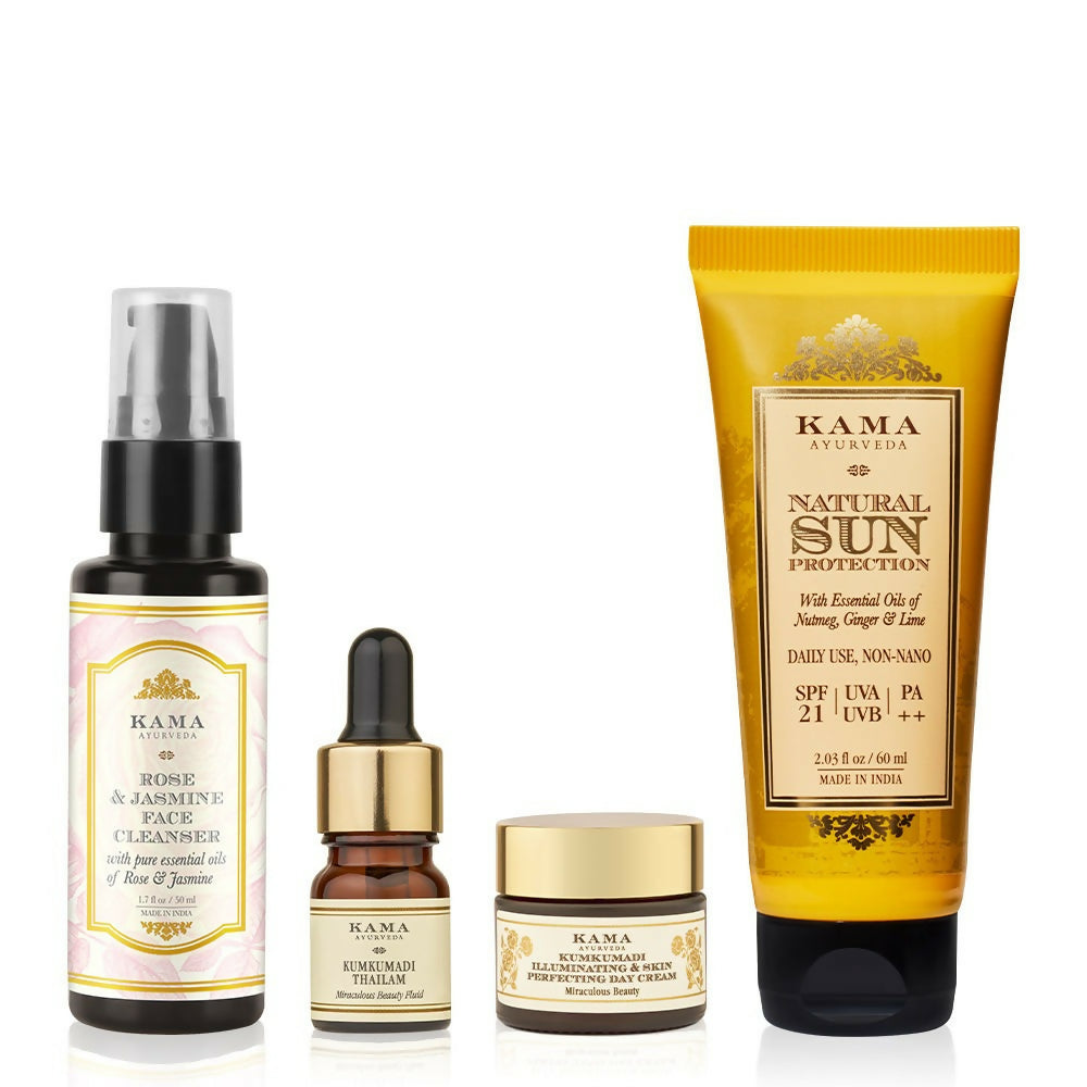 Set of Kama Ayurveda skincare products including cleanser, serum, cream, and sunscreen on a white background.